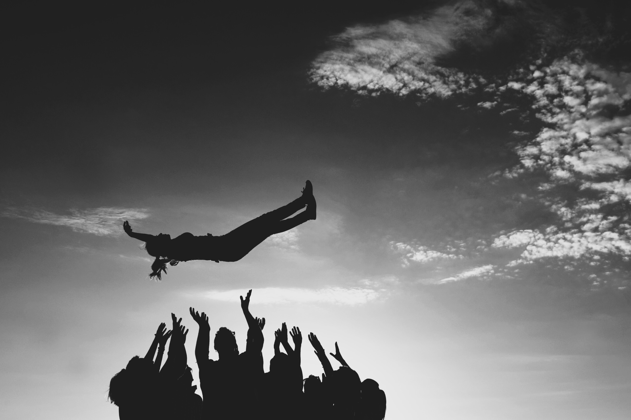 A team catching a colleague in a trust fall